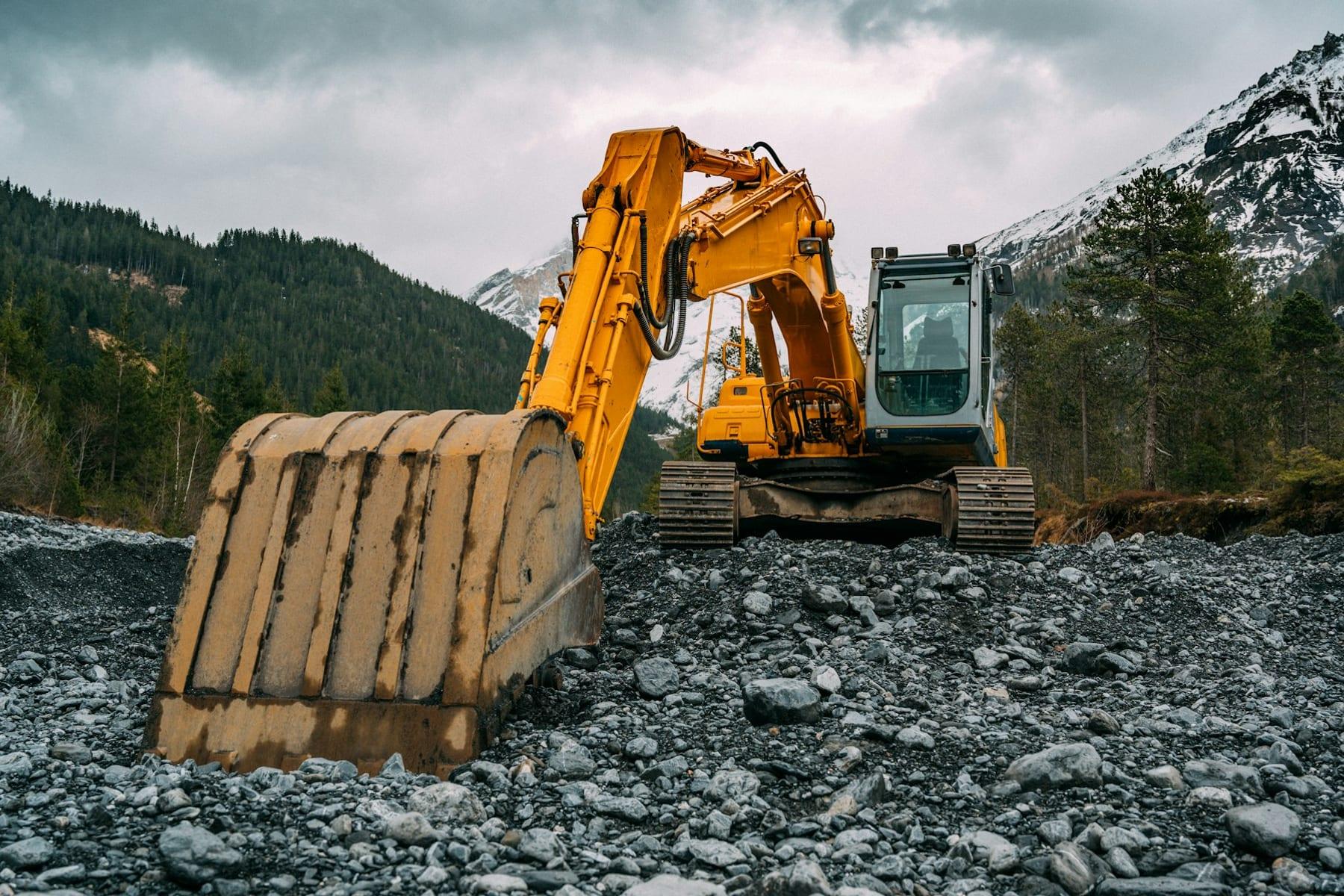 Construction excavator on a worksite — heavy machinery Maxcorro builds custom parts for